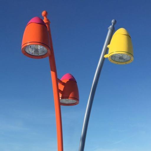Modern coloured ogord lantern model W38/2. The picture shows three neptune luminaires against a blue sky.